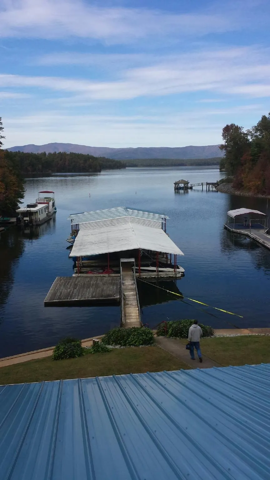 View across a lake from a newly installed blue metal roof in Nyack