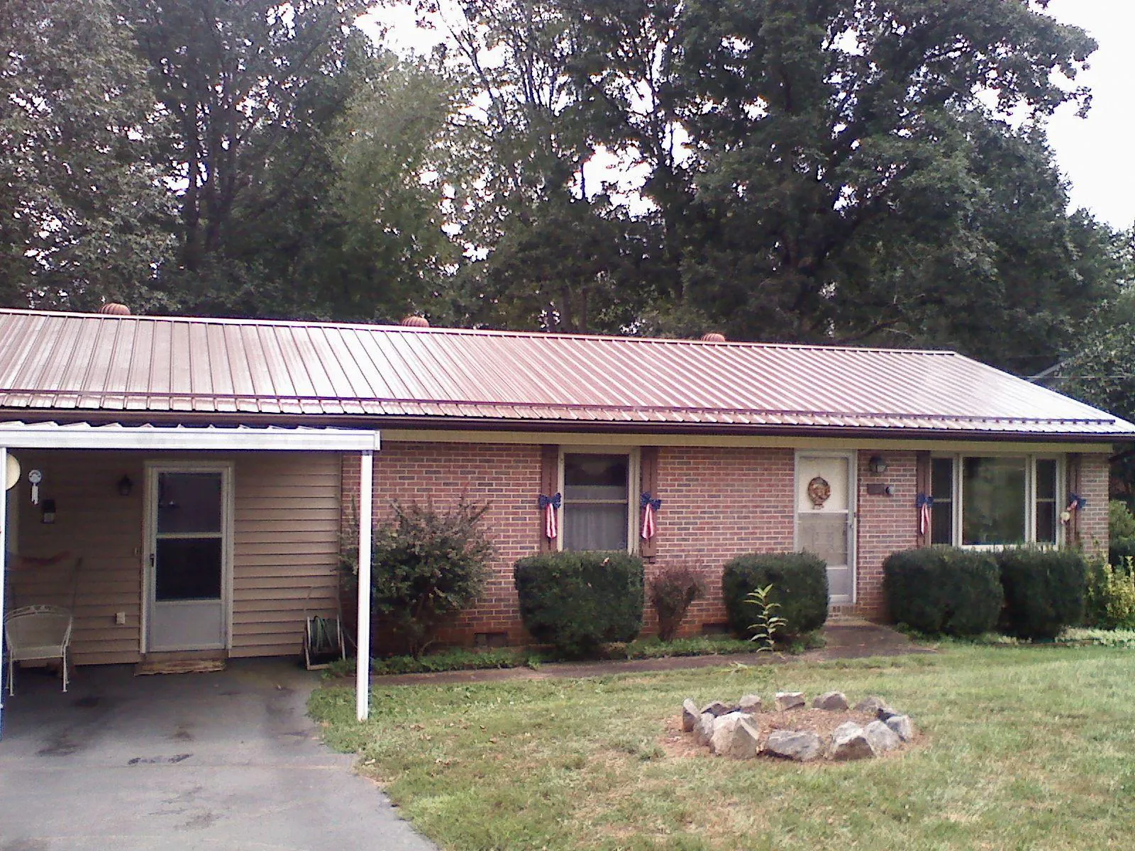 Bronze metal roof and carport on a brick ranch home — Roof Repair work by our crew in Nyack